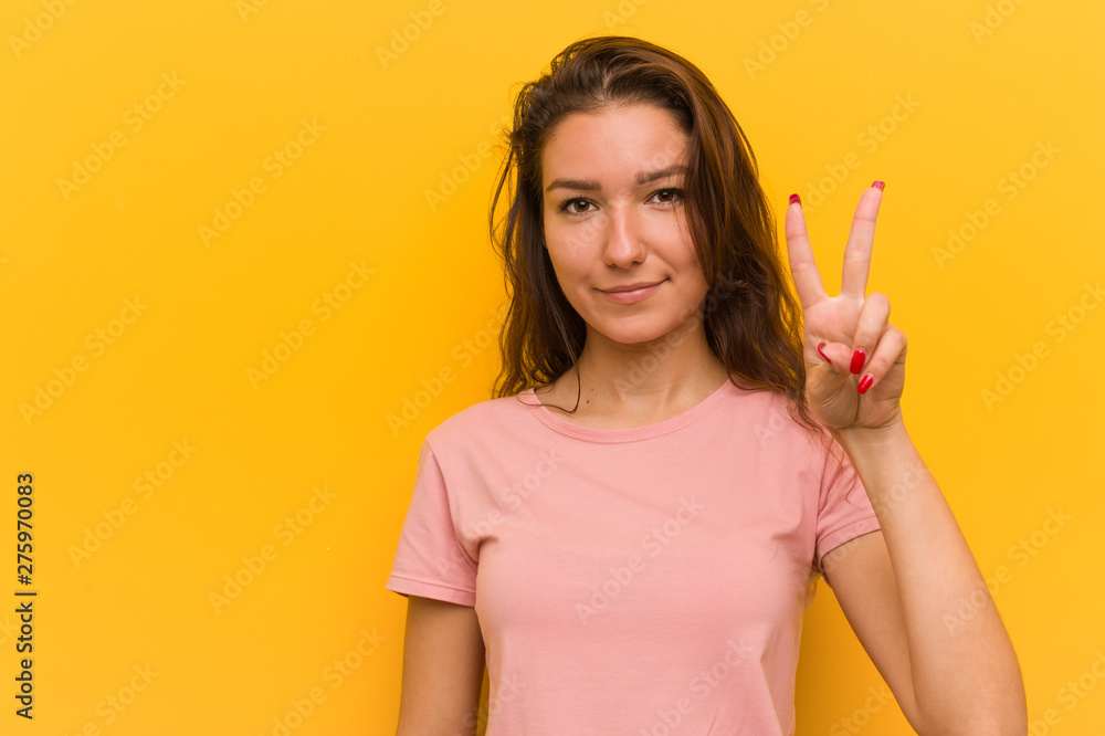 Young european woman isolated over yellow background showing number two with fingers. Young european woman isolated over yellow background showing number two with fingers.