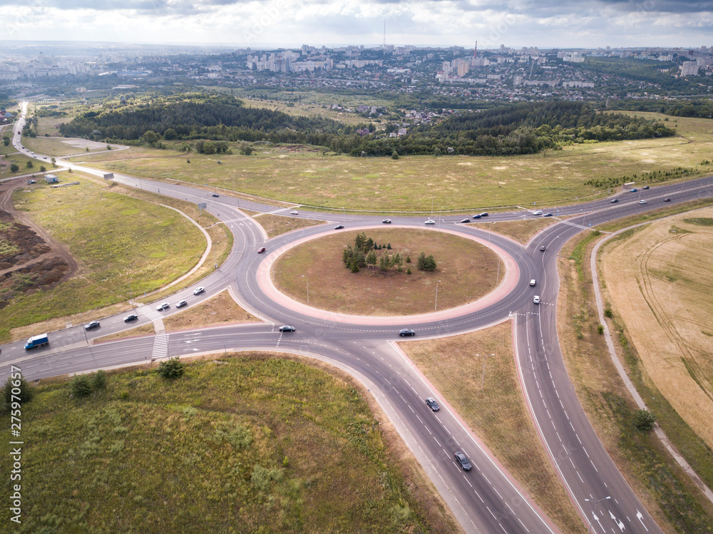 Top down aerial view of a traffic roundabout on a main road