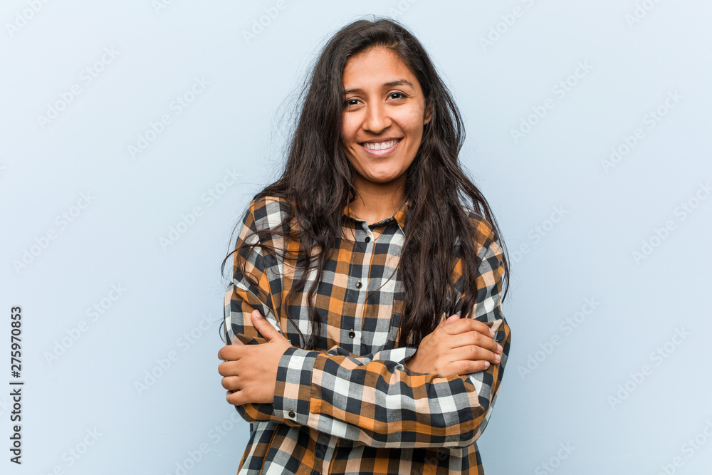 Young cool indian woman who feels confident, crossing arms with determination. Young cool indian woman who feels confident, crossing arms with determination.