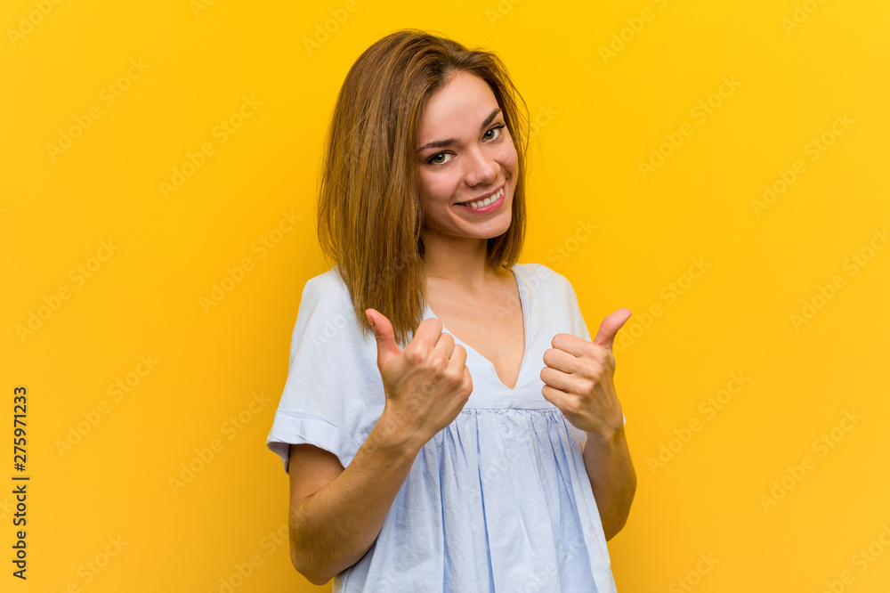 Young pretty young woman raising both thumbs up, smiling and confident. Young pretty young woman raising both thumbs up, smiling and confident.