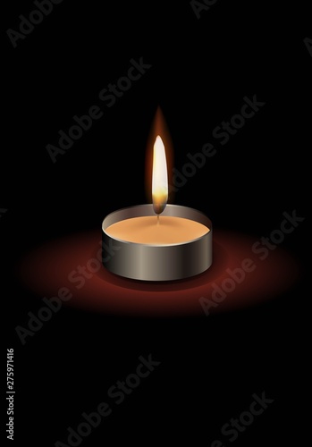 Small candle with a flame with a dark background