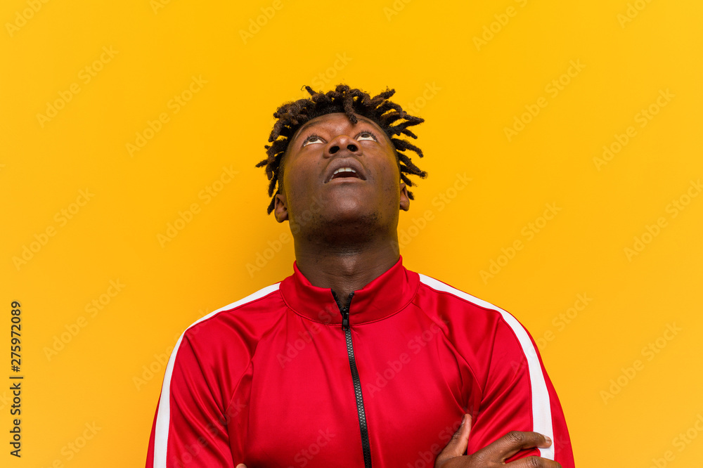 Fototapeta premium Young fitness black man tired of a repetitive task.
