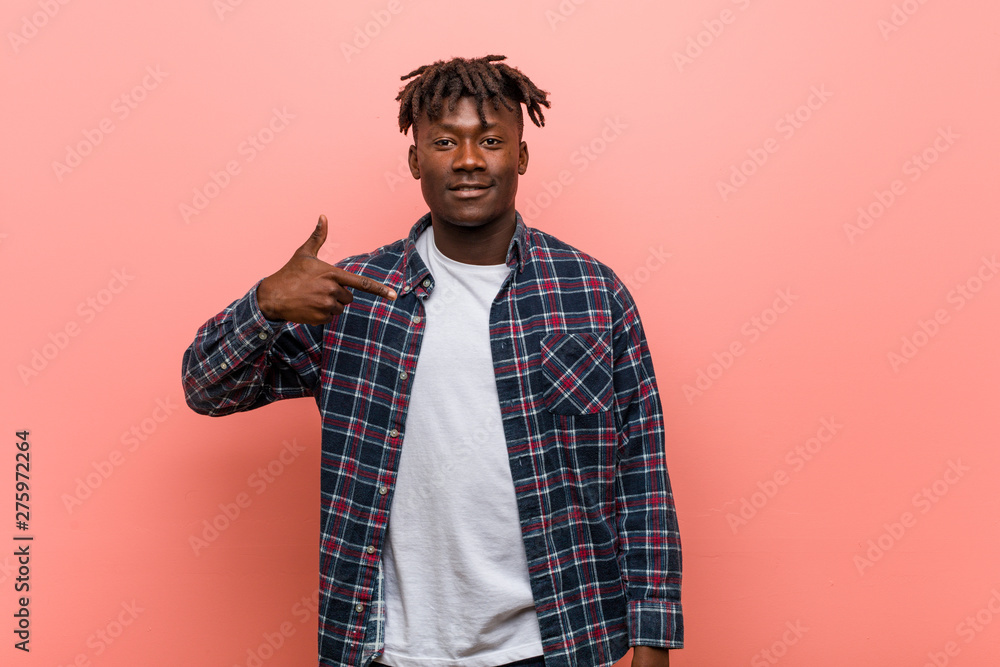 Young african black man person pointing by hand to a shirt copy space, proud and confident Young african black man person pointing by hand to a shirt copy space, proud and confident