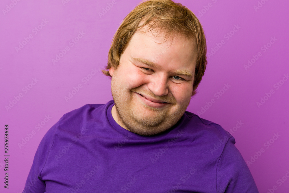 Young authentic redhead fat man laughs and closes eyes, feels relaxed and happy. Young authentic redhead fat man laughs and closes eyes, feels relaxed and happy.