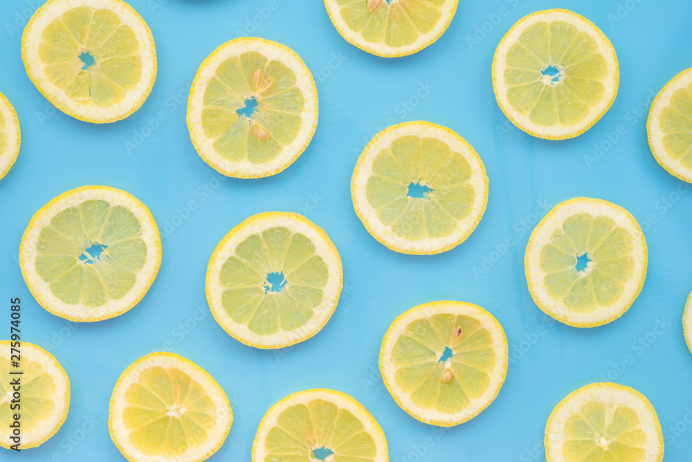 Lemon slices scattered on a blue background