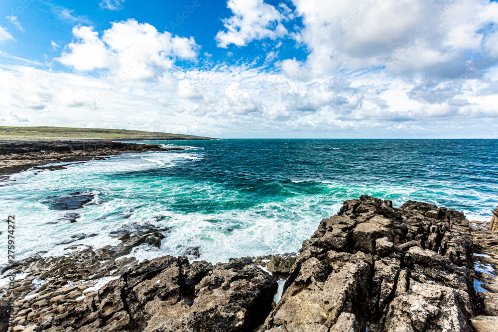 View of the horizon over the sea from a coastal cliff in Bothar nA hAillite, geoparks geosites, Wild Atlantic Way, wonderful sunny spring day in County Clare in Ireland