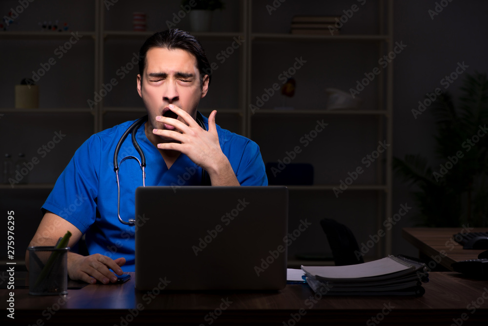 Young male doctor in the hospital at night Young male doctor in the hospital at night