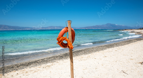 Lifebuoy on beautiful sandy beach and clear sea