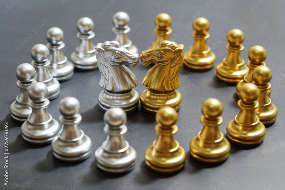 gold and silver chess on black background , focus on knight gold and silver chess on black background , focus on knight