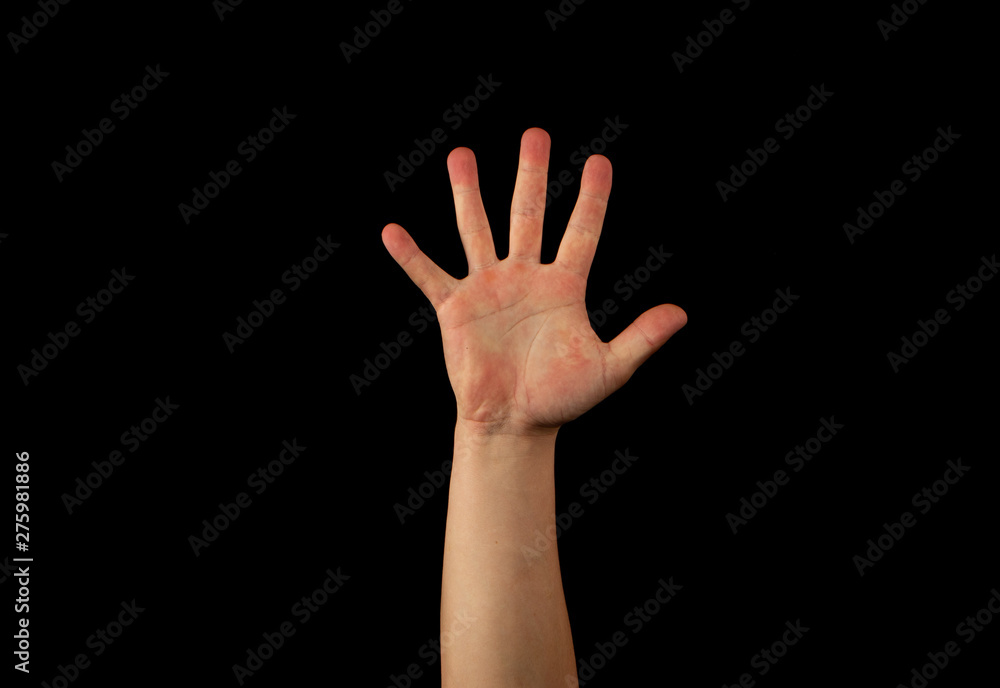 The hand of a young man on a black background The hand of a young man on a black background