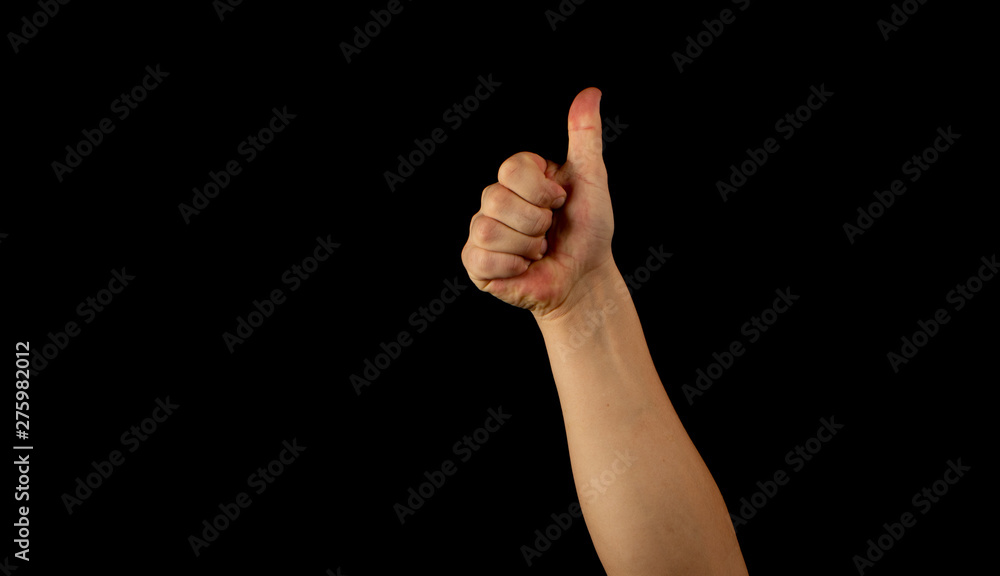The hand of a young man on a black background The hand of a young man on a black background