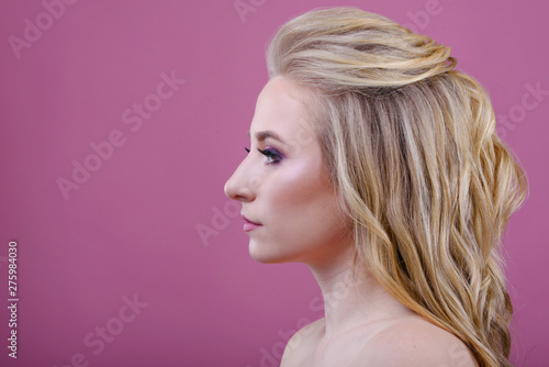 Beautiful girl portrait on a pink background.