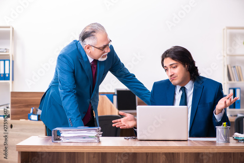 Young and old employees working together in the office 