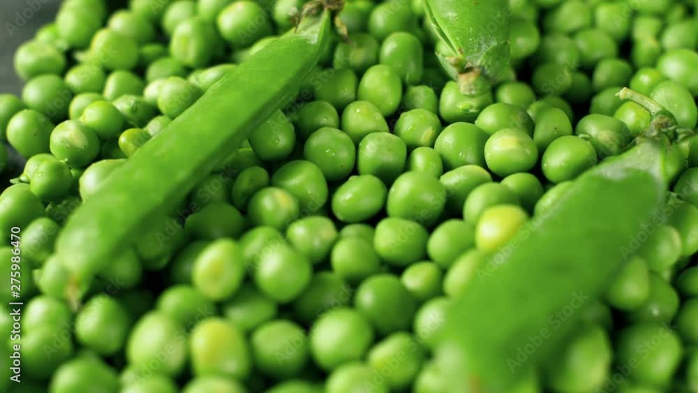 Rotating of fresh green pease and shells. Close up 4k footage of food. Top view. Rotating of fresh green pease and shells. Close up 4k footage of food. Top view.