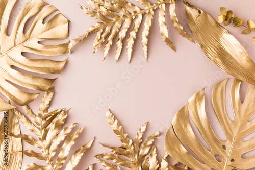 Flat lay of golden tropical leaf design elements. Decoration elements for inv...