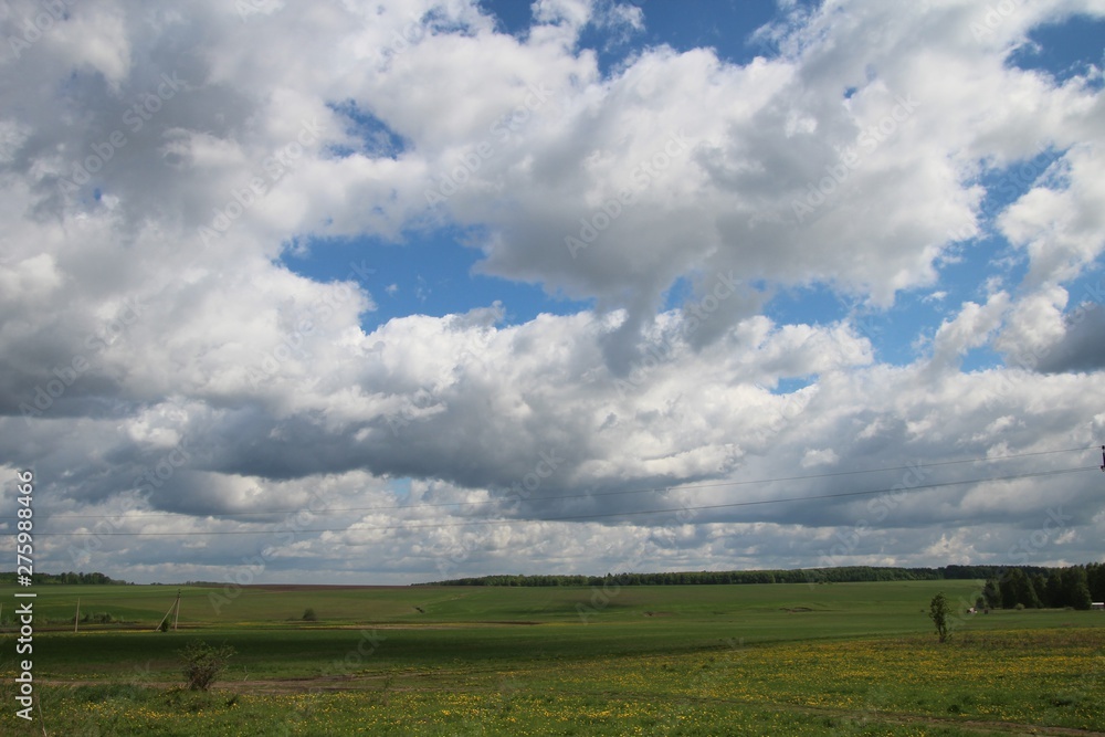 Rural landscape with blue sky and white clouds in Chuvashia