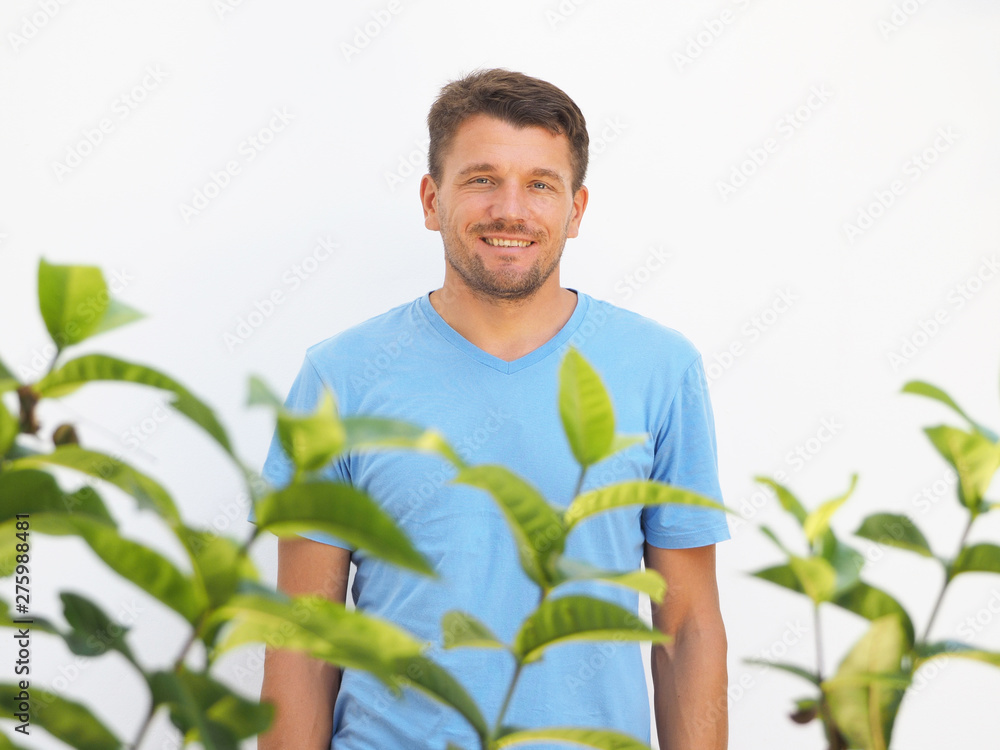 Portrait of a man smiling in a hotel against a white wall. Holiday in the Caribbean. Green Garden. Portrait of a man smiling in a hotel against a white wall. Holiday in the Caribbean. Green Garden.