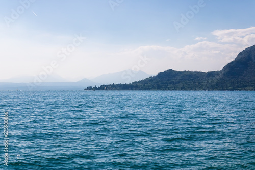 Panorama of the Garda lake surrounded by mountains, Italy - Image