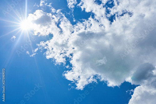 Blue sky with beautiful  gray-white  clouds and brightly shining sun