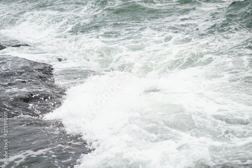 sea waves on a stone beach, splashing water