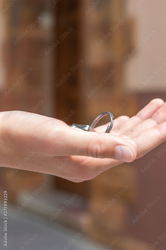 A bunch of keys to the apartment in the hand of a man on the background of a brown house A bunch of keys to the apartment in the hand of a man on the background of a brown house