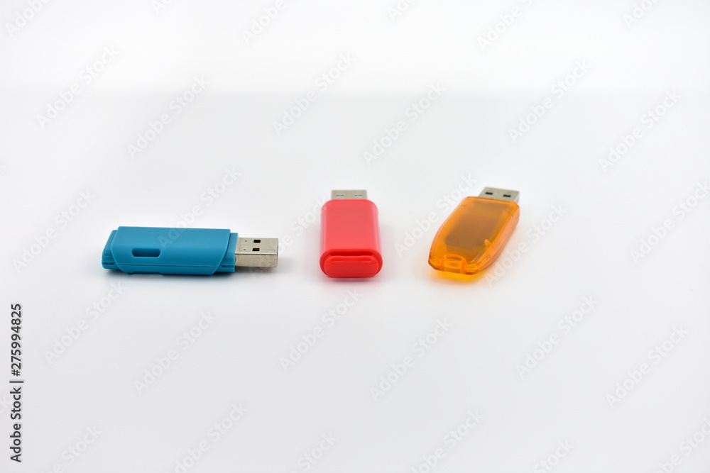 USB flash memory drives with colours on a white background. USB flash memory drives with colours on a white background.