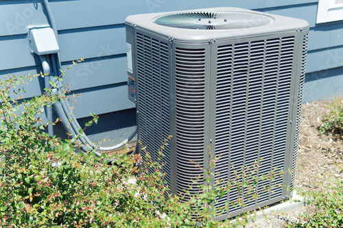 A/C unit connected to residential house photo