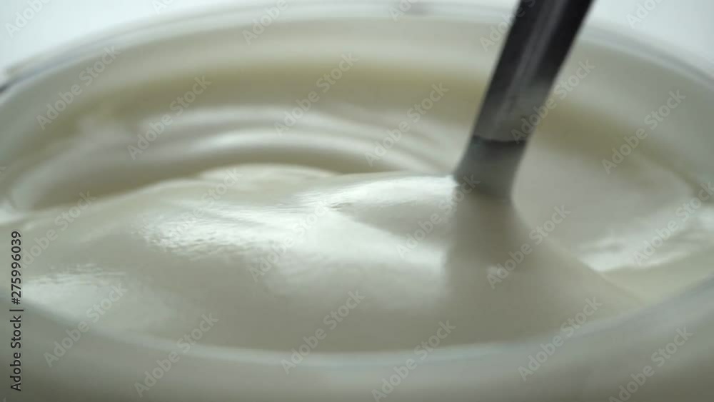 macro - video shooting,Slow motion of mixing yogurt with spoon in the cup macro - video shooting,Slow motion of mixing yogurt with spoon in the cup