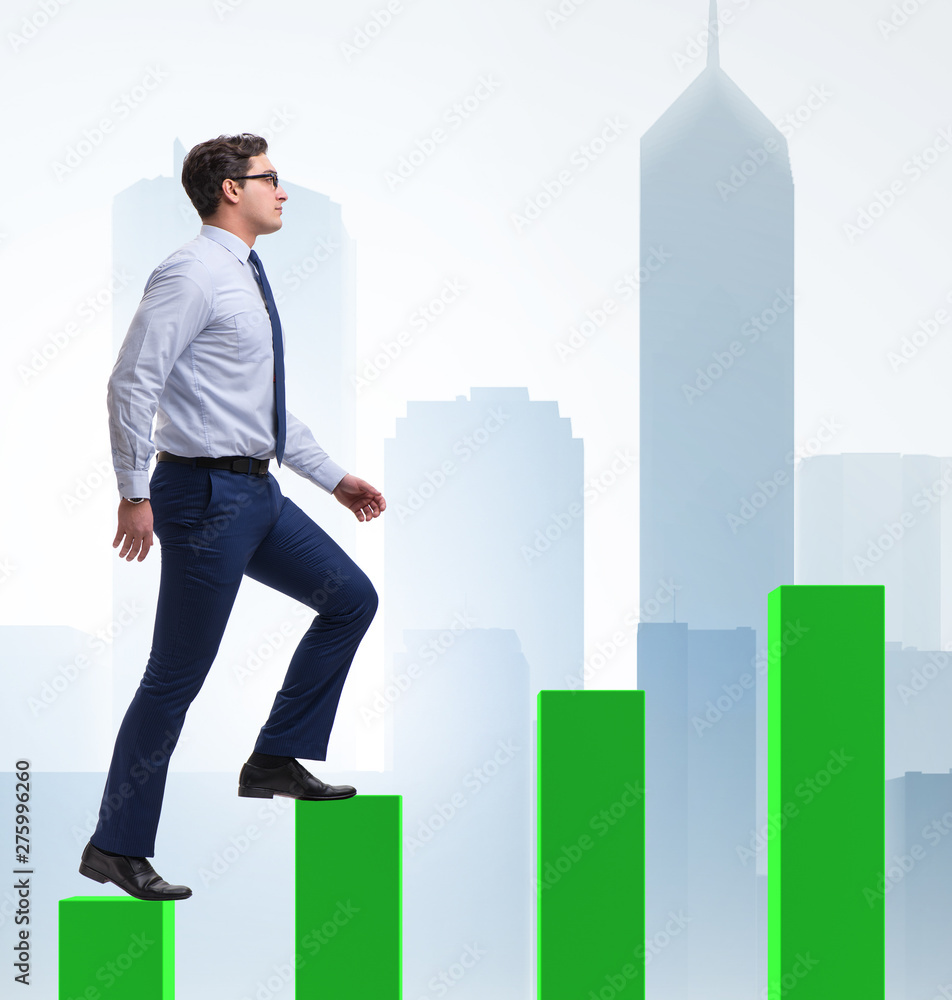 Businessman going up the bar chart in growth concept Businessman going up the bar chart in growth concept