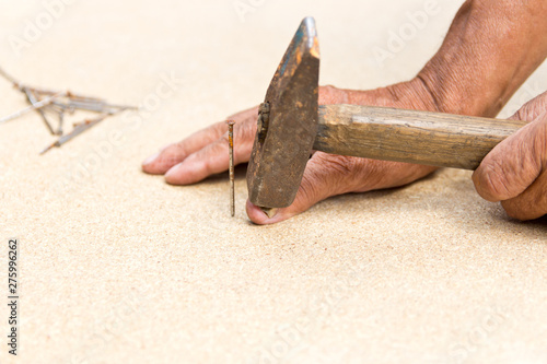 The man hit his finger with a hammer. Professional carpentry, woodwork and people. concept of injury in the workplace. Copy space photo