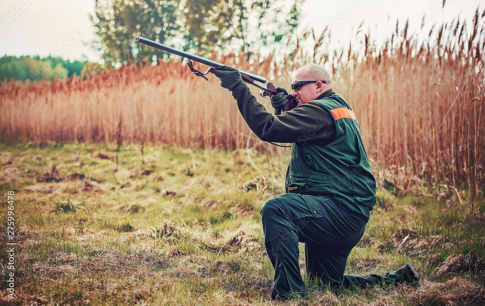 Fototapeta premium Hunter with a rifle in hunting