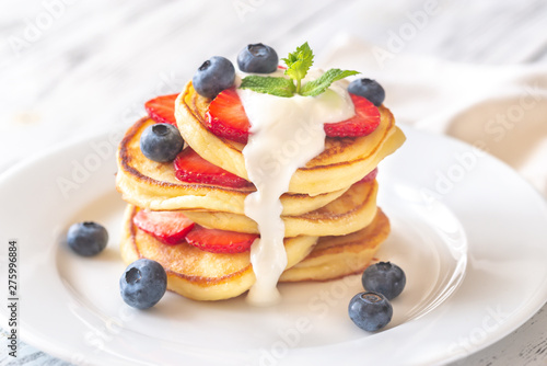 Portion of ricotta fritters with fresh berries