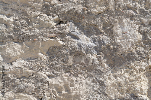 Stone and cement grungy old vintage gray outdoor wall surface