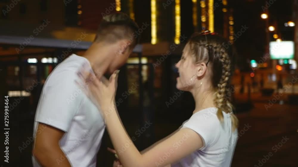 happy couple are having fun posing on the street of night city.slow motion happy couple are having fun posing on the street of night city.slow motion