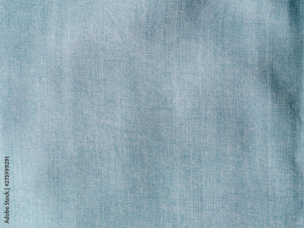 Modern soft jeans blouse texture close up. Lyocell or tencel pattern - modern natural cellulose fabric blue denim color. Can use for design or text. Copy space Modern soft jeans blouse texture close up. Lyocell or tencel pattern - modern natural cellulose fabric blue denim color. Can use for design or text. Copy space