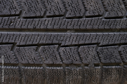 Old tire texture background. Worn black tire tread