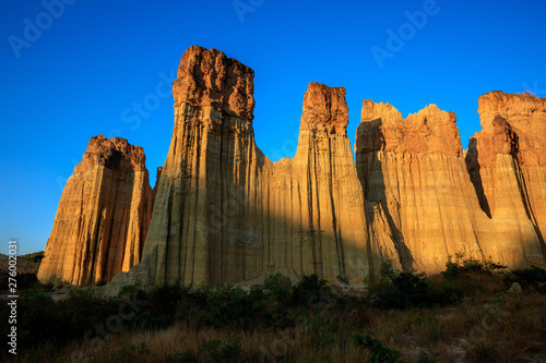 Earth Forest of Yuanmou in Yunnan Province, China - Exotic earth and sandstone formations glowing in the sunlight. Naturally formed pillars of rock and clay with unique erosion patterns. China Travel