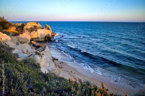Bay at sunset, surrounded by cliff, next to Praia da Galé,  Albufeira, Portugal