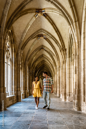 couple men and woman walking by the church in Utrecht, Dom Church Utrecht, The Cathedral of Saint Martin Utrecht Dom Church Netherlands  photo