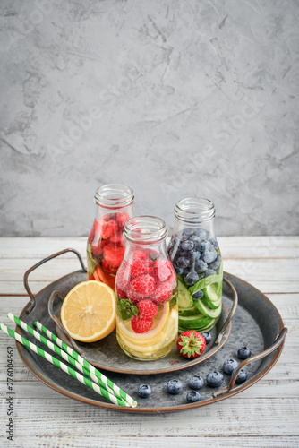 Infused water with fresh fruits, vegetables and berry in bottles