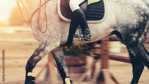 The leg of the rider in the stirrup