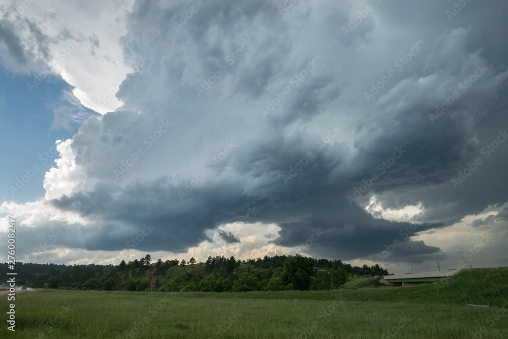 Two rotating wall clouds of a severe supercell thunderstorm . At this moment very large hailstones felt from this storm. Two rotating wall clouds of a severe supercell thunderstorm . At this moment very large hailstones felt from this storm.