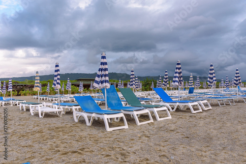 Sunbeds and umbrellas on the calabrian beach © mkos83