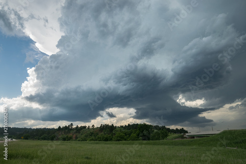 Two rotating wall clouds of a severe supercell thunderstorm . At this moment very large hailstones felt from this storm.