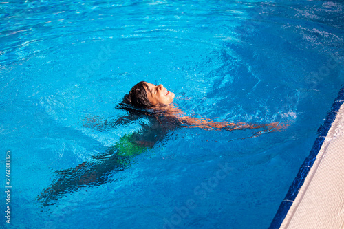 young boy swimming in pool