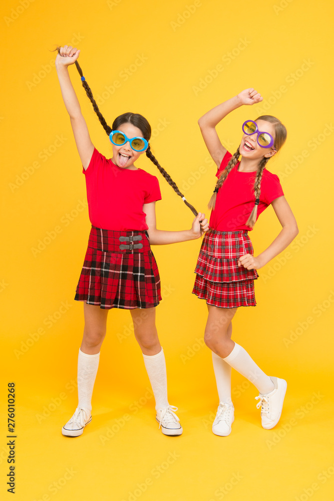 Small girls wearing fancy glasses. Funny kids in sun glasses. summer vacation. party time. school prom party. red fashion girls. happy little girls in checkered skirt. funny kids in school uniform Small girls wearing fancy glasses. Funny kids in sun glasses. summer vacation. party time. school prom party. red fashion girls. happy little girls in checkered skirt. funny kids in school uniform