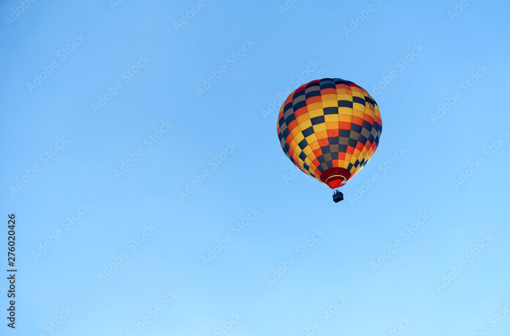 Hot air colourful baloon over blue sky. Traveling by balloon Hot air colourful baloon over blue sky. Traveling by balloon