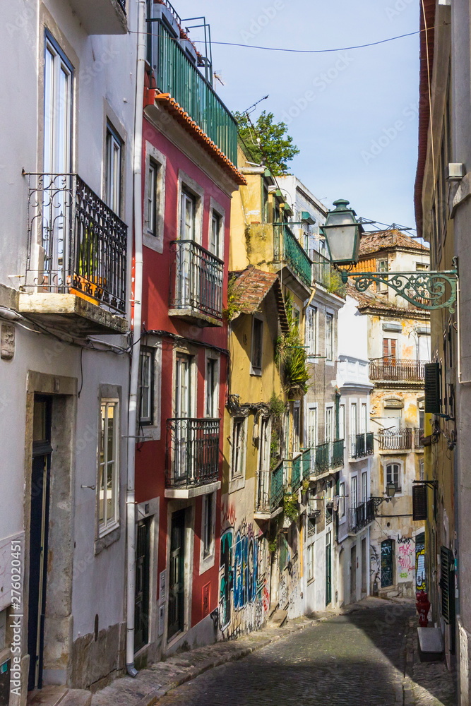 Lisbon, Portugal - May 18, 2019: Street perspective view with colorful traditional houses