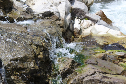 Cold water flows in a mountain stream photo