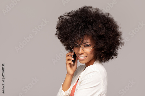 Beautiful afro woman talking by mobile phone.